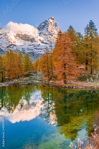 Blue Lake and the surroundings area during the fall and changing of the colors. Foliage, reflection and snowy peaks.