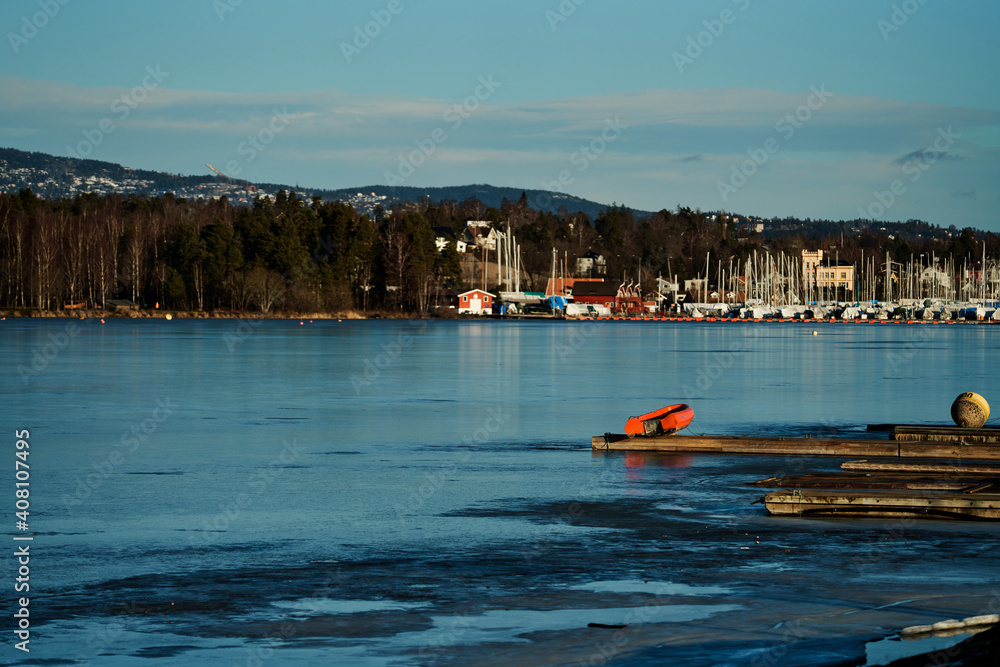 Fototapeta premium Outdoors at Kalvøya, Sandvika, Bærum, Norway. Ice cold winter day, but the sun is shining and is heating a little bit.