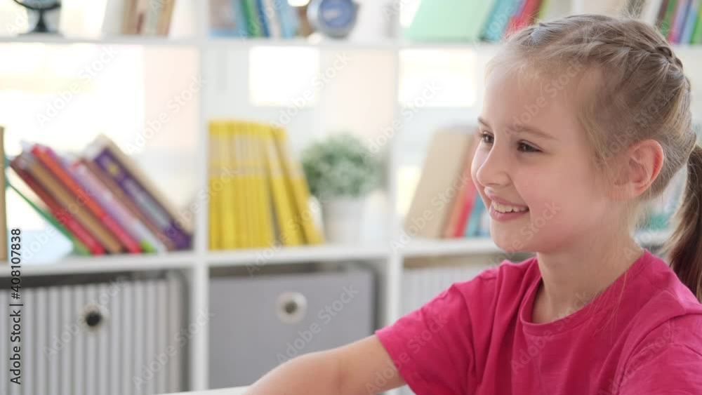 Portrait of happy little girl answering at lesson in school Portrait of happy little girl answering at lesson in school