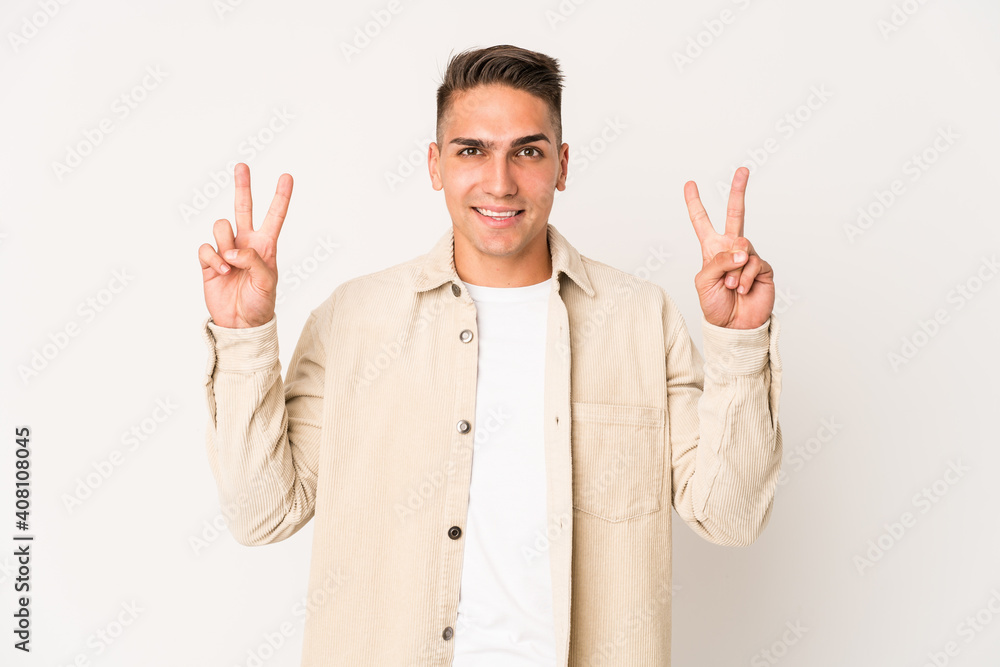 Young caucasian handsome man isolated showing victory sign and smiling broadly. Young caucasian handsome man isolated showing victory sign and smiling broadly.