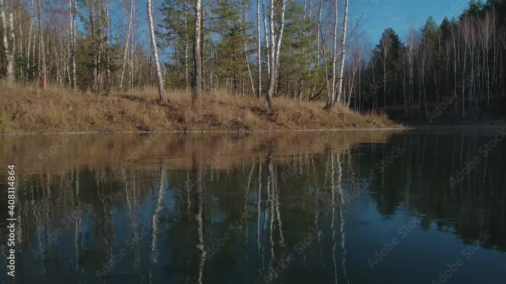 The drone flies very low along the shore of a frozen lake The drone flies very low along the shore of a frozen lake