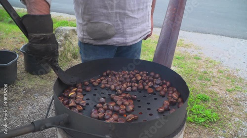 Man roast chestnuts on an open fire