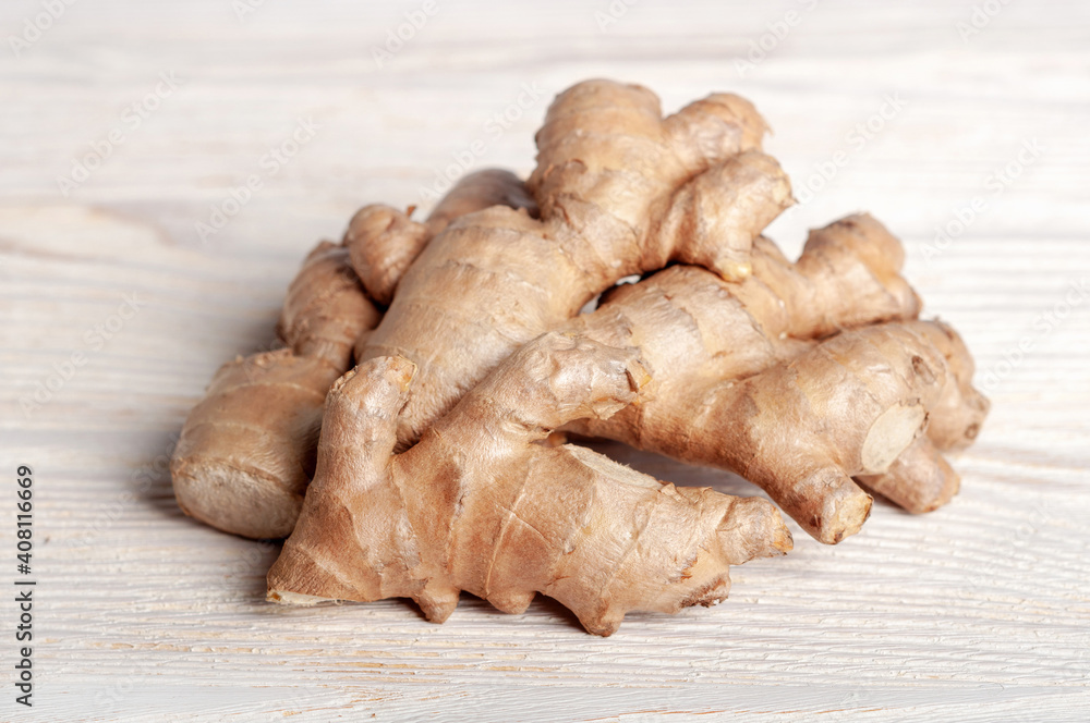 Fresh ginger root on a wooden table.