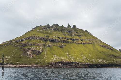 Top view vertical composition with the iconic Drangarnir gate, Tindholmur and mykines island in the background, Faroe Islands