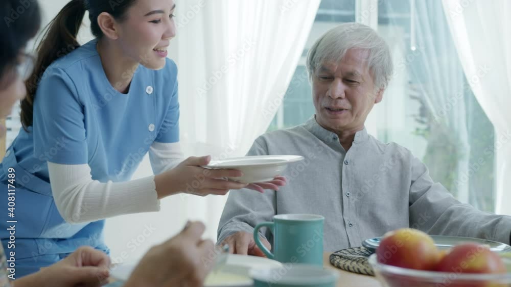 Attractive young senior asian citizen couple happy sit, talk, eat soup for healthy nutrition breakfast meal on dining table at home in morning in routine lifestyle in old asia nursing in-home care. Attractive young senior asian citizen couple happy sit, talk, eat soup for healthy nutrition breakfast meal on dining table at home in morning in routine lifestyle in old asia nursing in-home care.