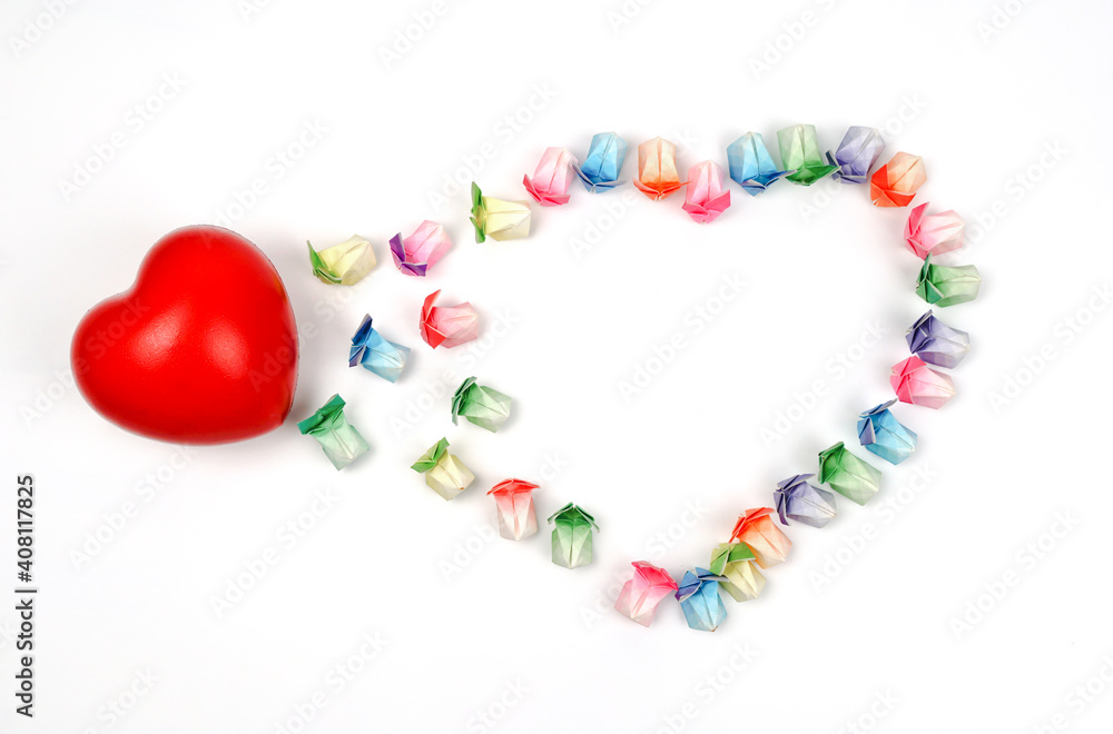 Various colored paper folded in the shape of a rabbit arranged in a heart with a red heart on a white background. Various colored paper folded in the shape of a rabbit arranged in a heart with a red heart on a white background.