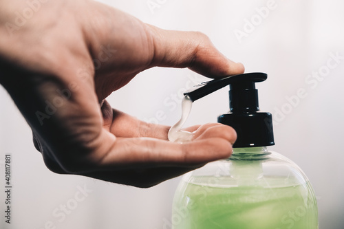 A young man washes his hands photo
