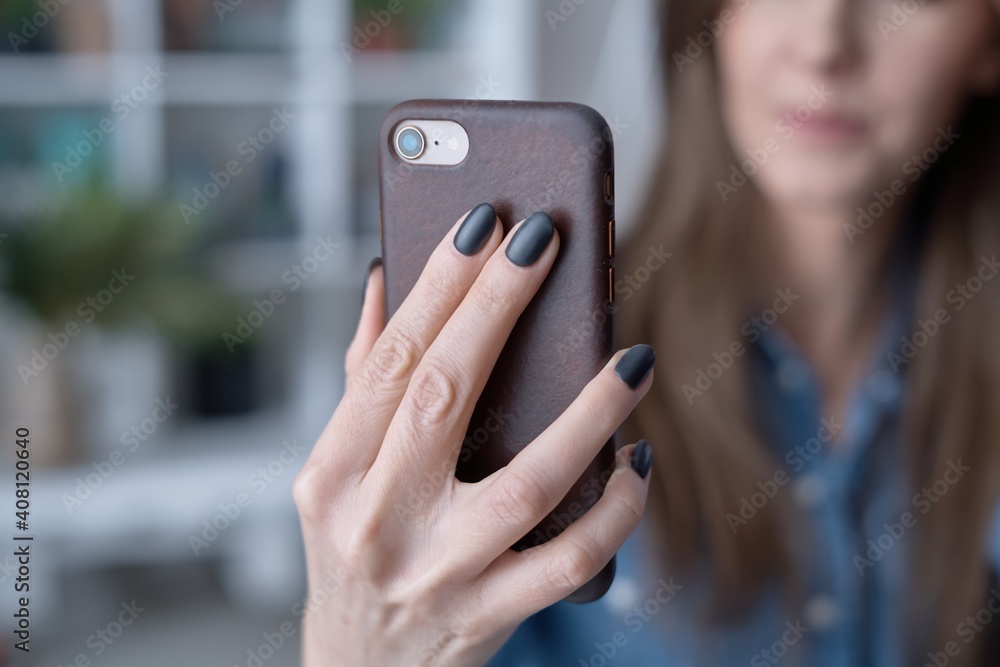 Fototapeta premium close up image of woman holding phone, video calling, using online mobile chat app.