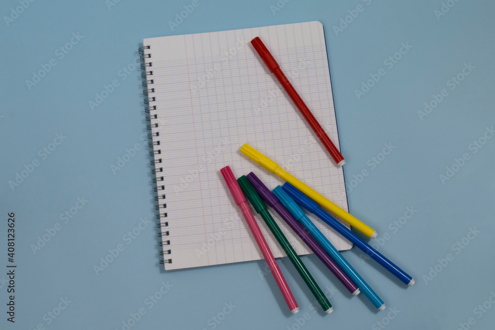 Copyspace blank sheet of white paper covered with multiple colorful felt pen markers Copyspace blank sheet of white paper covered with multiple colorful felt pen markers