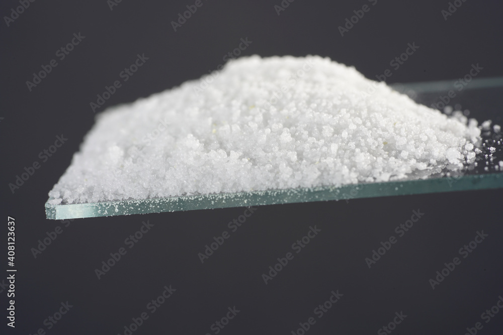 Makrogol powder photographed against a black background in the studio Makrogol powder photographed against a black background in the studio