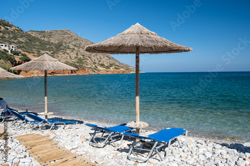 Crete Greece Plaka Lassithi with is traditional blue table and chairs and the beach in Crete Greece. Paralia Plakas, Plaka village Crete. Europe photo