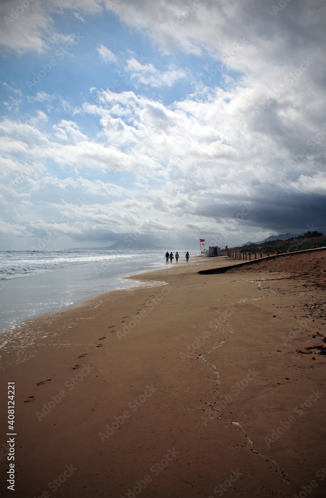 An image of the beach on a cloudy summer day