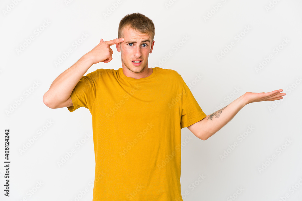 Young caucasian handsome man holding and showing a product on hand. Young caucasian handsome man holding and showing a product on hand.