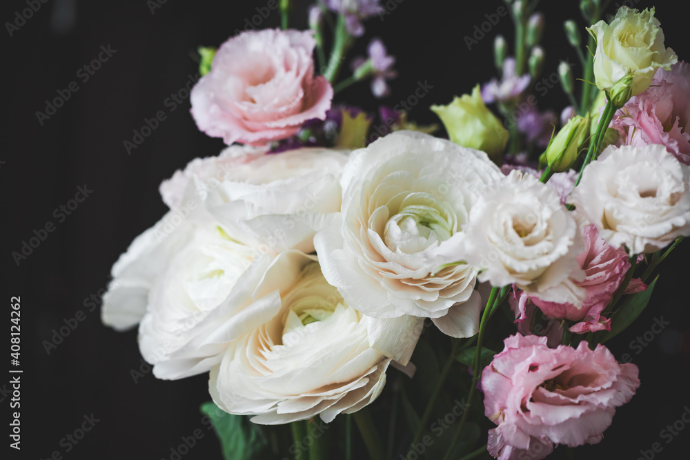 Beautiful bouquet of flowers with white ranunculus. Wedding bouquet on black background, closeup view, soft tones Beautiful bouquet of flowers with white ranunculus. Wedding bouquet on black background, closeup view, soft tones