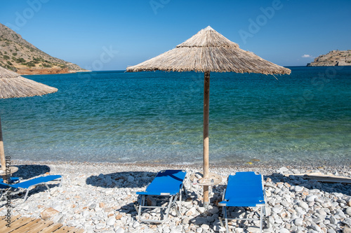 Crete Greece Plaka Lassithi with is traditional blue table and chairs and the beach in Crete Greece. Paralia Plakas, Plaka village Crete. Europe photo