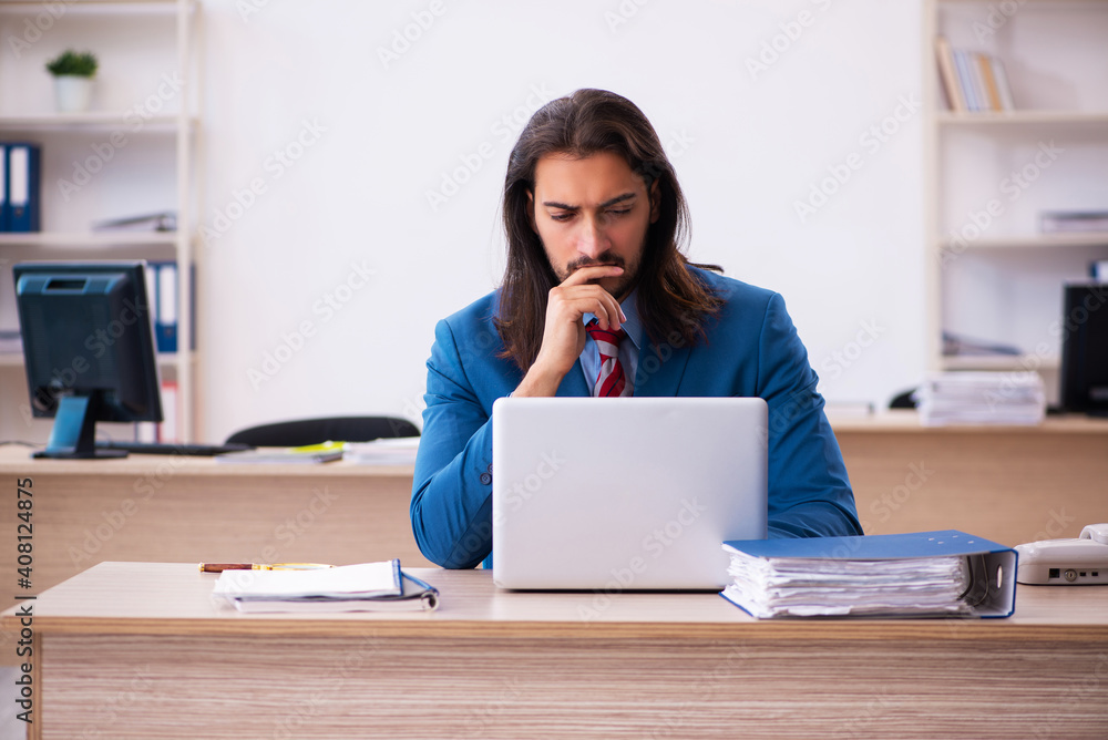 Young male employee working at workplace Young male employee working at workplace