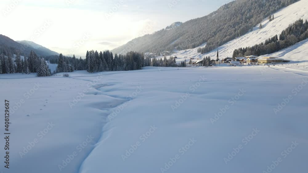 Winter Landscape In The Mountain Village Of Balderschwang In Bavaria, Germany - aerial drone shot Winter Landscape In The Mountain Village Of Balderschwang In Bavaria, Germany - aerial drone shot