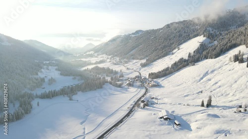 Town Of Balderschwang Between Alpine Mountains In Germany On A Sunny Day In Winter Season. - aerial photo