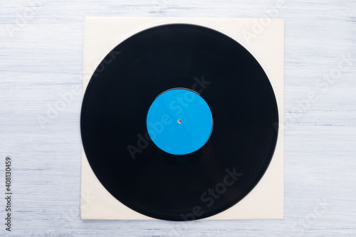 on a light gray background, on a paper envelope, lies a vinyl record, close-up