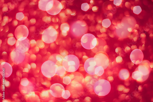 Abstract defocused red background for holidays. Festive Valentine's Day and Christmas background with red boke lights. Red blurred greeting card.