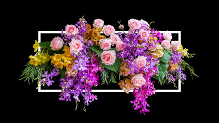 Flower bush of pink roses and tropical orchids flowers with green leaves foliage floral arrangement nature wedding or Valentines day backdrop with white frame on black background.