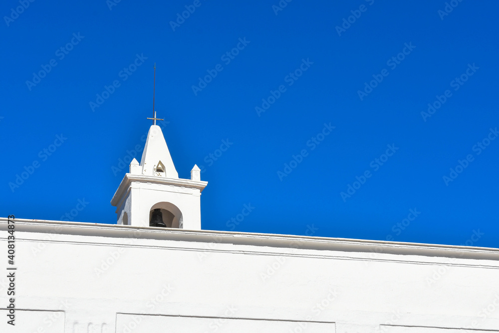 Obraz premium Ibiza, Spain - January 17, 2021: Ibiza San Miguel Sant Miquel de Balansat white Mediterranean church on a sunny day..