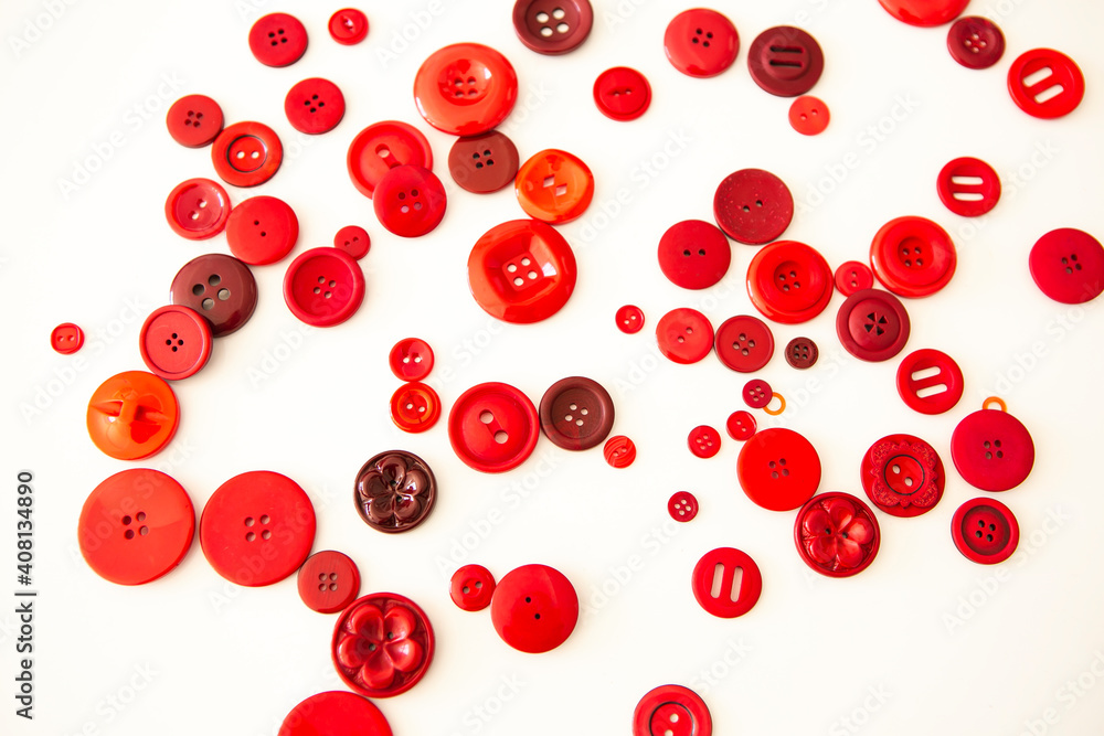 group of red buttons of different sizes on white background group of red buttons of different sizes on white background