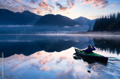 Adventurous Girl kayaking on an infatable kayak in a beautiful lake. Colorful peaceful Sunrise Art Render. Taken in Stave Lake, East of Vancouver, British Columbia, Canada. Adventure, vacation concept photo