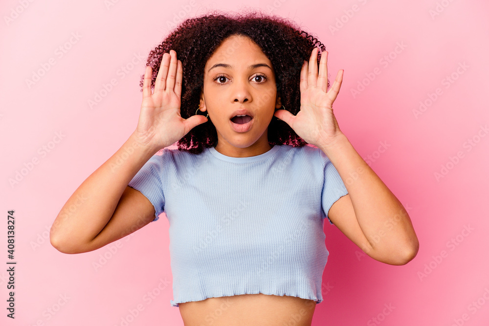 Young african american mixed race woman isolated surprised and shocked. Young african american mixed race woman isolated surprised and shocked.