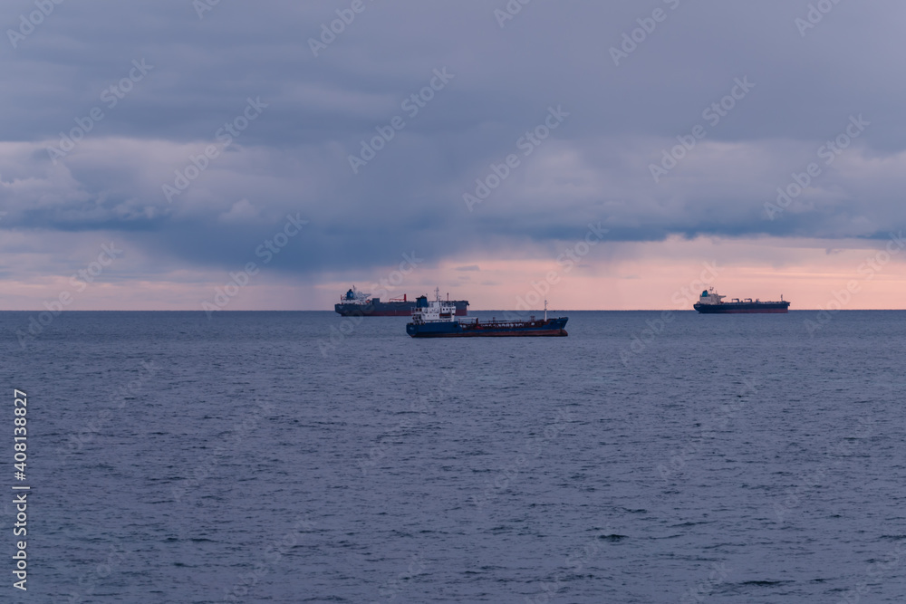 Three merchant ships on calm waters at sea
