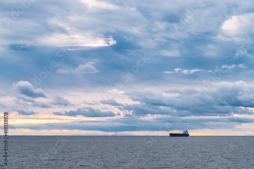 the ship sails on the sea against the backdrop of a beautiful cloudy sky.