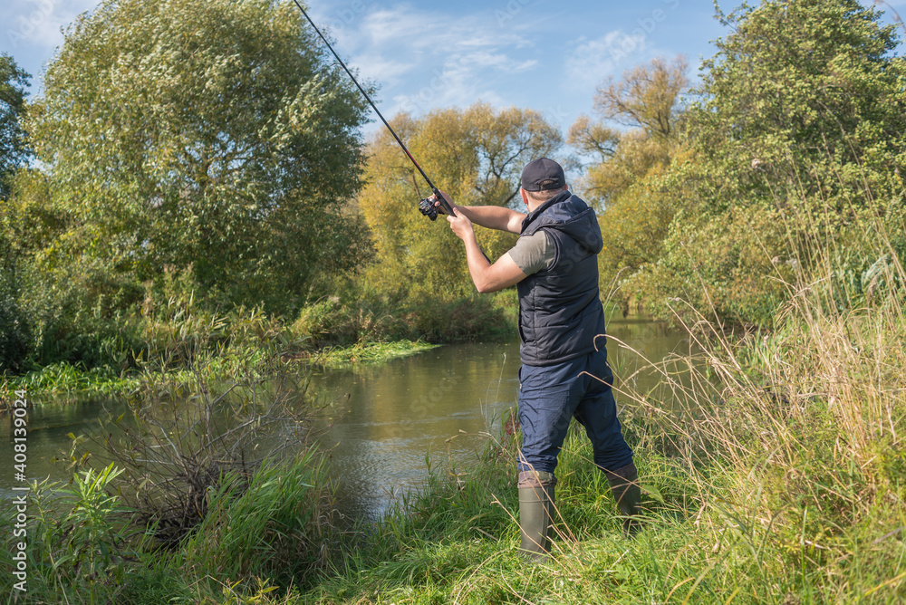 Young man fishing on the river. Outdoor recreation. Young man fishing on the river. Outdoor recreation.