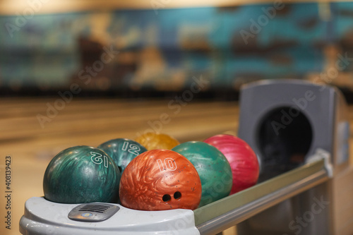Background image of several bowling balls on rack in bowling alley center  copy space