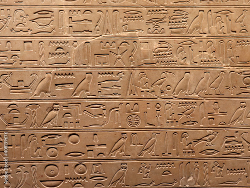 Egyptian hieroglyphs on a stone wall. The language of an ancient civilization.