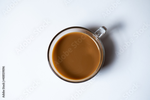 Clear glass of white coffee on white background