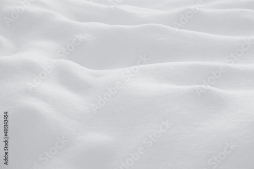 Background with white snow. Snow drifts, hills and mountains.