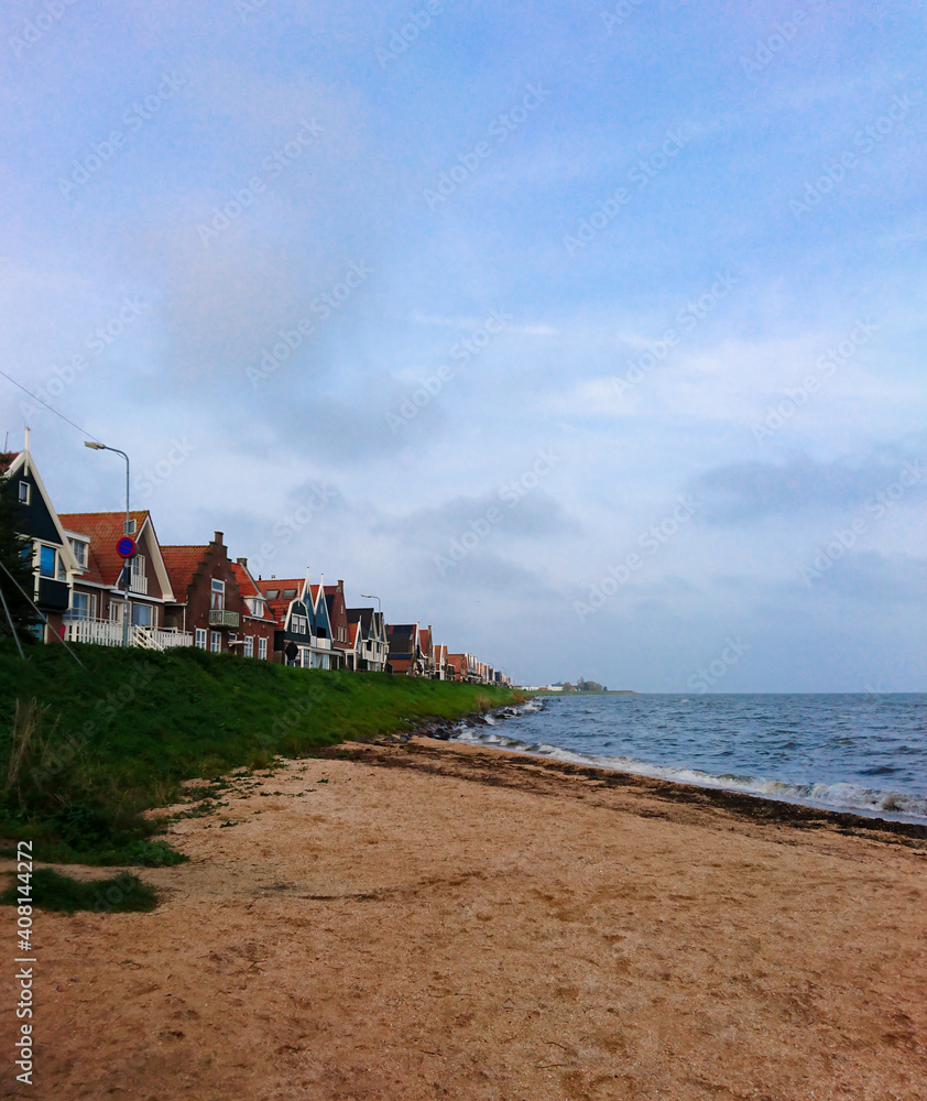Beautiful landscape from famous village of Volendam in Netherlands. Sea shore and typical houses of Volendam.