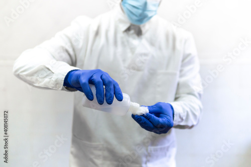 Doctor, nurse, scientist, researcher hand in blue gloves holding flu, measles, coronavirus, covid-19 vaccine disease preparing for human clinical trials vaccination shot, medicine and drug concept.