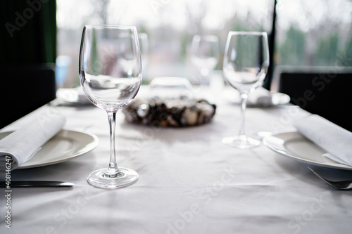 serving the table. wine glasses, plates, napkins and cutlery. design of the table for a festive dinner. service in a restaurant or cafe.