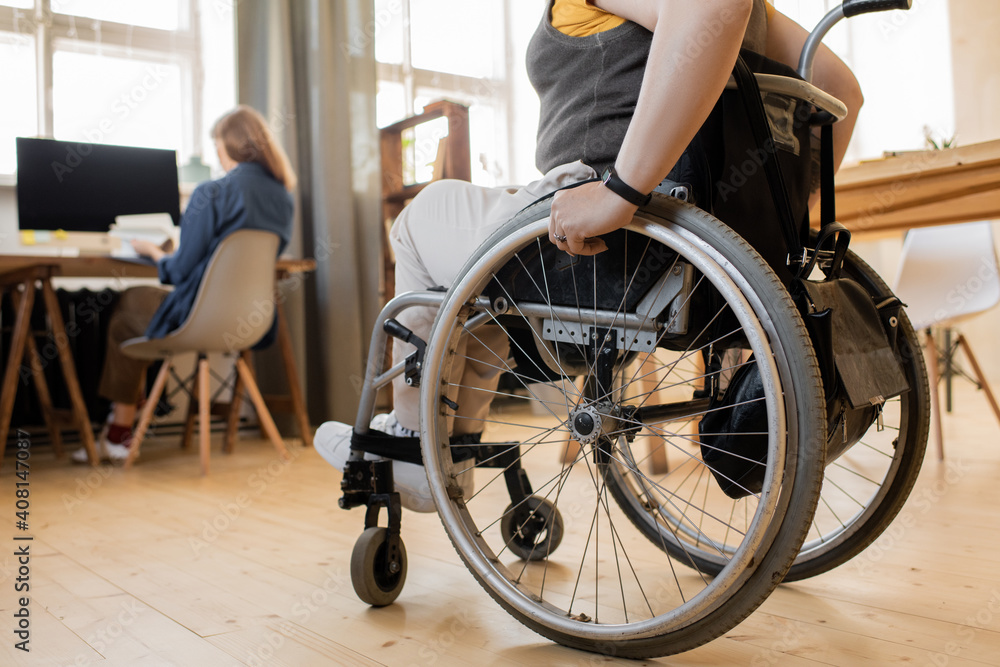 Obraz premium Low section of young disable female sitting in wheelchair in front of camera
