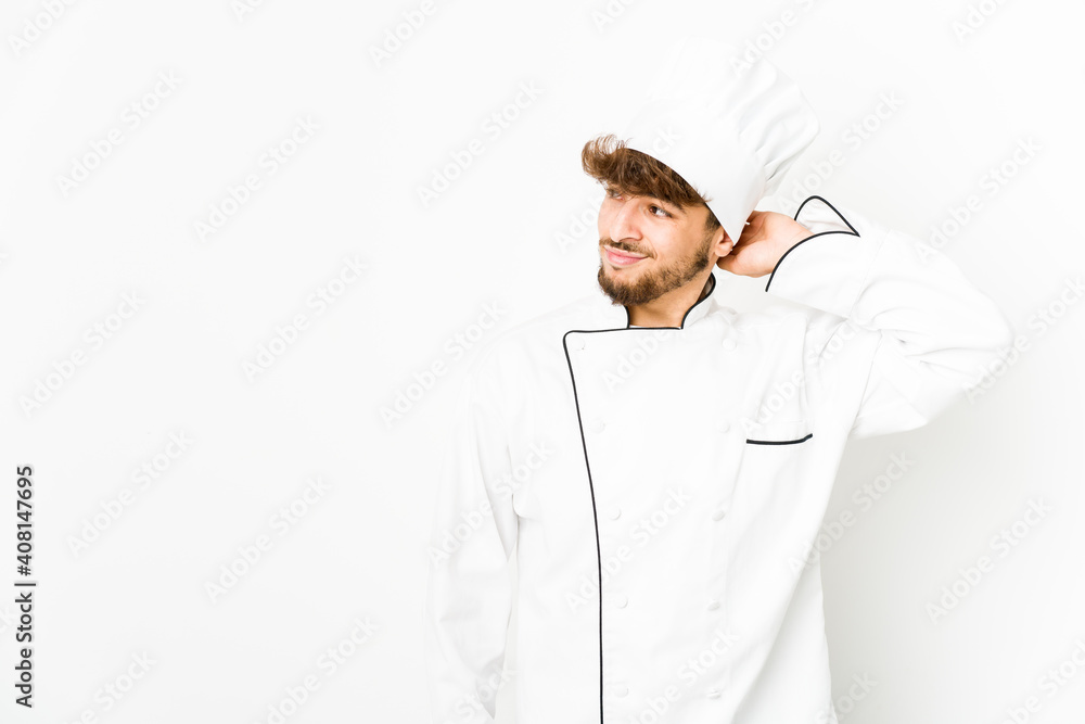 Young arab cook man touching back of head, thinking and making a choice. Young arab cook man touching back of head, thinking and making a choice.
