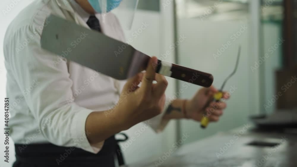 Crop Image Of A Cook In Restaurant Spinning The Griddle Spatula On His Finger. - Medium, Slow Motion Crop Image Of A Cook In Restaurant Spinning The Griddle Spatula On His Finger. - Medium, Slow Motion