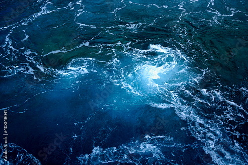 Deep sea background with rippled water and swirl of sea foam on the surface