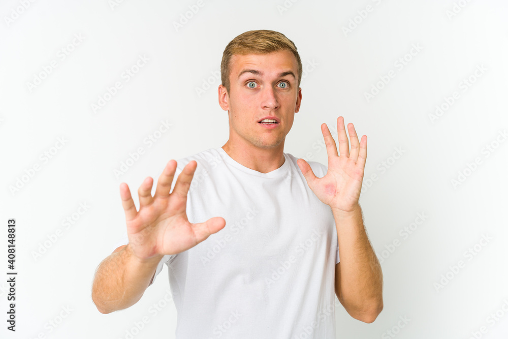 Young caucasian handsome man being shocked due to an imminent danger Young caucasian handsome man being shocked due to an imminent danger