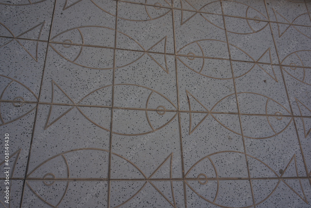 A high angle shot of a tiled floor with fish patterns