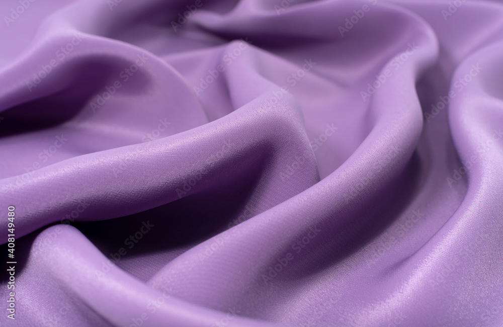 Obraz premium A piece of purple cloth. Fabric texture for background and design works of art, beautiful wrinkled pattern of silk or linen. A crumpled piece of cloth