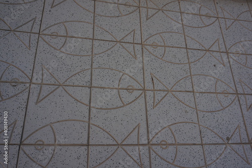 A high angle shot of a tiled floor with fish patterns