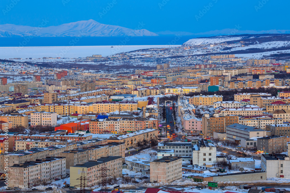 Aerial cityscape view of Magadan. Portovaya street and the arch with the text in Russian 