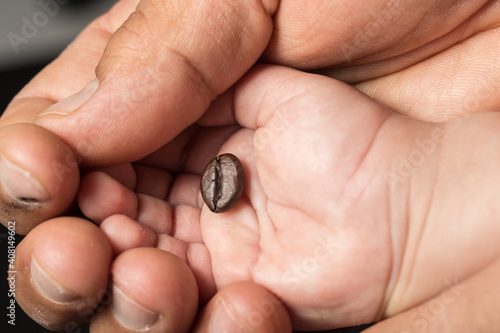 coffee beans in a baby's hand