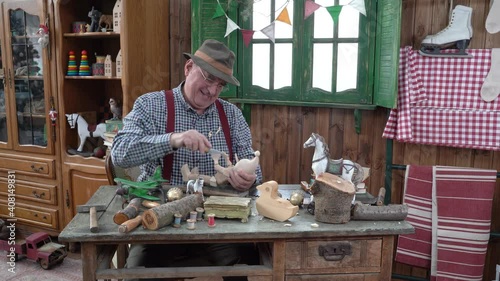 The creation of Pinocchio in the carpentry workshop of the woodworker Gepetto Papa Carlo . Children's fairy tales . A wooden doll with a long nose . photo